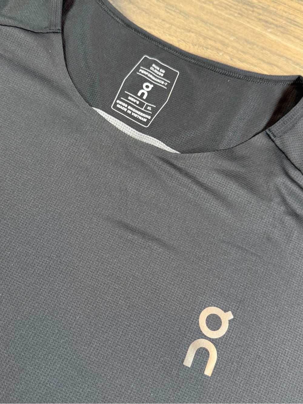 On Running Men’s Black Short Sleeve PerformanceT with Silver Logo